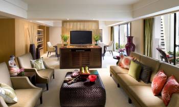 a living room filled with furniture and a flat screen tv