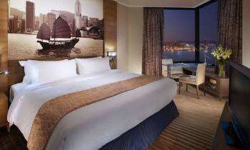 a bedroom with a large bed in a hotel room