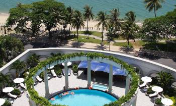 a pool next to a palm tree