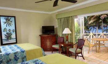 a bedroom with a bed and a chair in a room