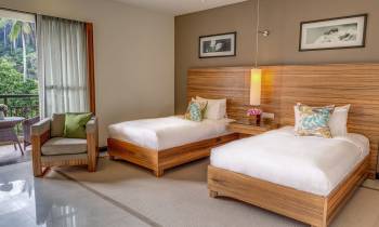 a bedroom with a bed and desk in a room