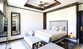 a bedroom with a bed and desk in a room