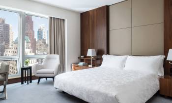 a bedroom with a large bed in a hotel room