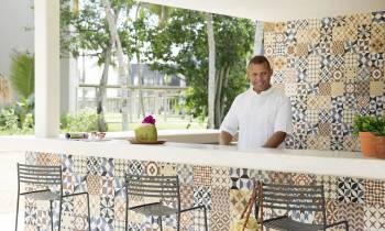 a man sitting at a table in front of a window