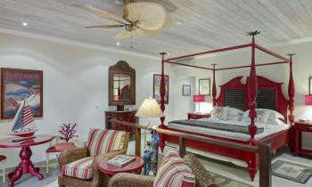 a bedroom with a bed and desk in a room