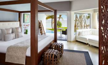 a bedroom with a bed and a chair in a room