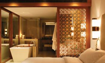 a bedroom with a bed and a mirror