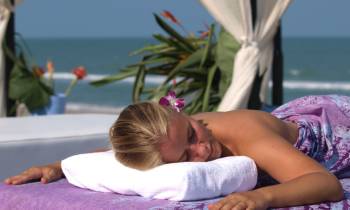 a little girl lying on a bed