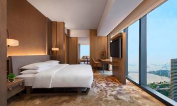 a bedroom with a large bed in a hotel room