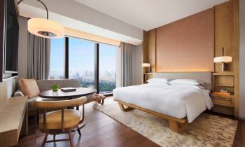 a bedroom with a bed and desk in a room