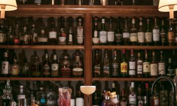 a row of beer glasses on a shelf