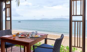 a chair sitting in front of a body of water