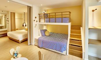 a bedroom with a bed and a mirror in a room