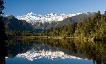 Lake Matheson with a mountain in the background