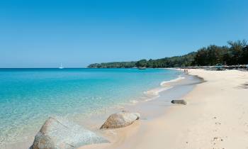 a sandy beach next to a body of water