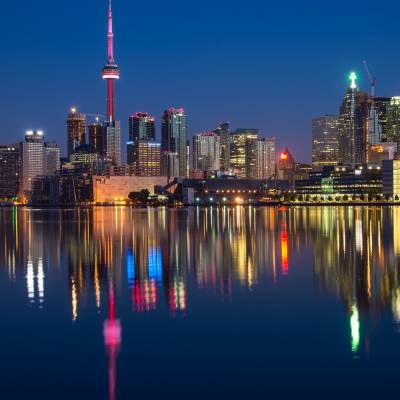 a body of water with a city in the background