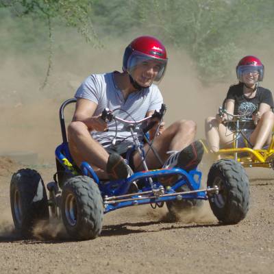 a man riding a bike down a dirt road
