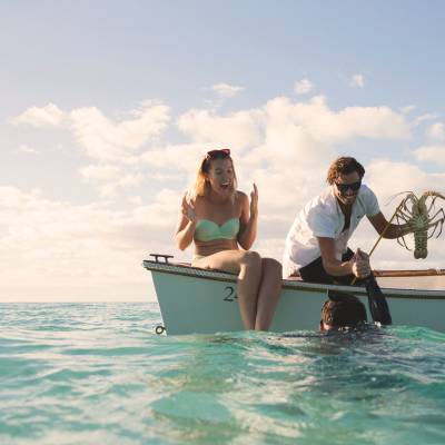 a person riding on the back of a boat in the water