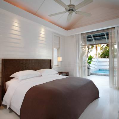a bedroom with a bed and a large window