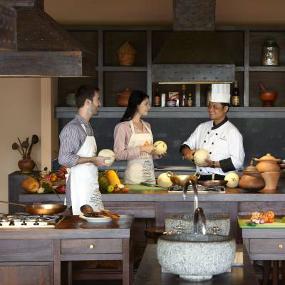 a man and woman cooking food in a kitchen