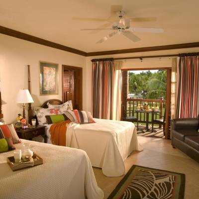 a living room filled with furniture and a bed in a bedroom