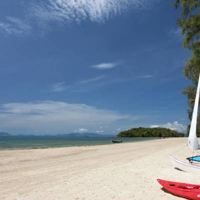 a boat sitting on top of a sandy beach