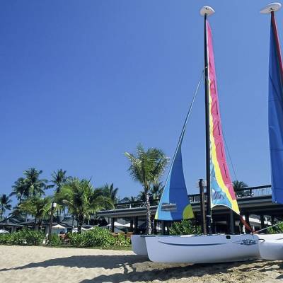 a large white boat sitting next to a body of water