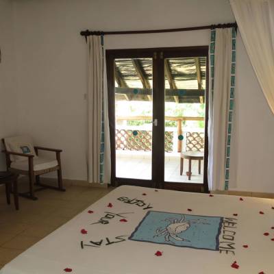 a bedroom with a bed and desk in a room