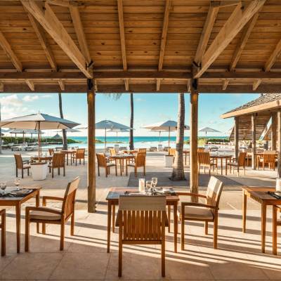 a group of lawn chairs sitting on top of a wooden table