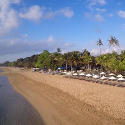 a row of cars on a sandy beach
