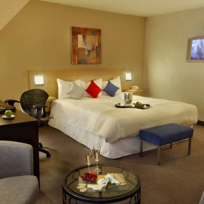 a bedroom with a bed and a chair in a room