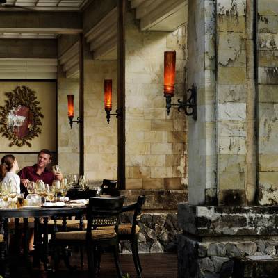 a group of people sitting at a table in front of a building