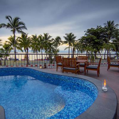 a group of palm trees next to a pool of water