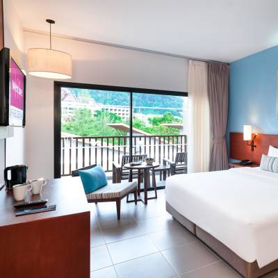 a bedroom with a bed and a table in a room