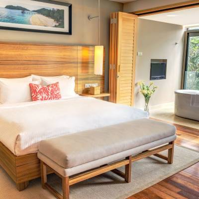 a bedroom with a bed and a chair in a room