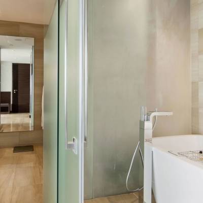 a large white tub sitting next to a shower