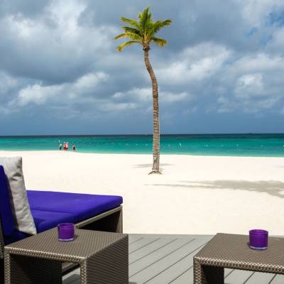 a couple of lawn chairs sitting on top of a beach