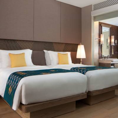 a bedroom with a bed and desk in a hotel room