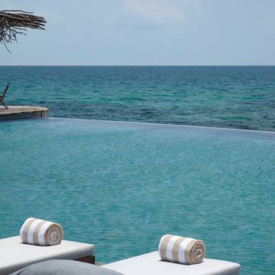 a chair sitting in front of a body of water