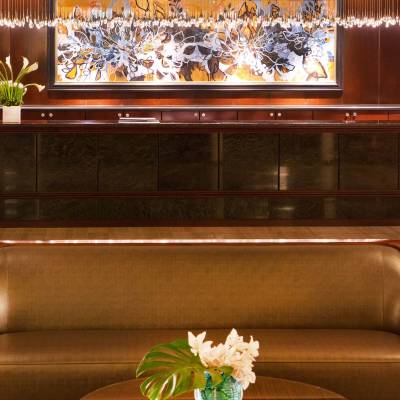 a living room filled with furniture and vase of flowers on a table