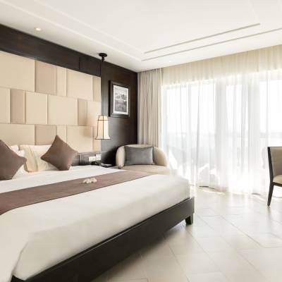 a bedroom with a large bed in a hotel room