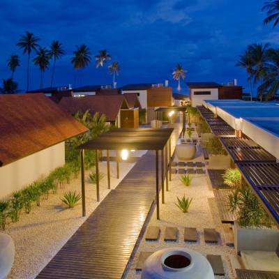 a building with a pool in front of a palm tree