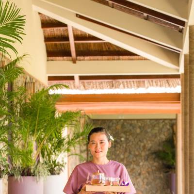 a person standing next to a palm tree in front of a window