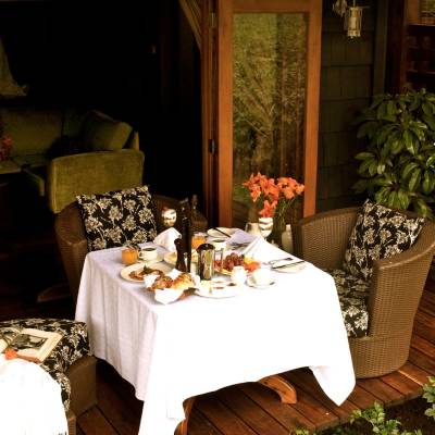 a room with a couch and a table in a garden