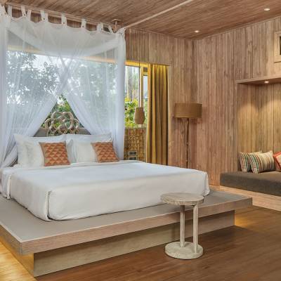 a bedroom with a fireplace and table in a room