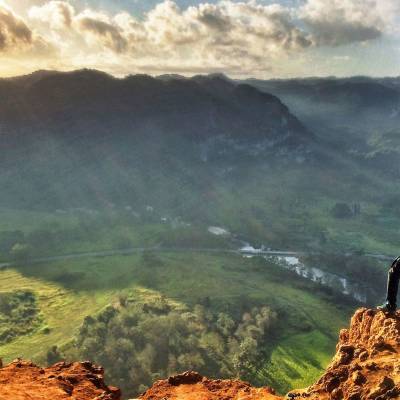a man standing on a rocky hill