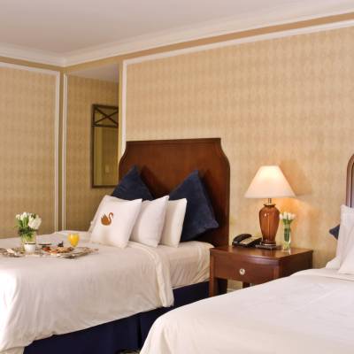 a large white bed in a hotel room