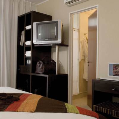 a bedroom with a bed and a television