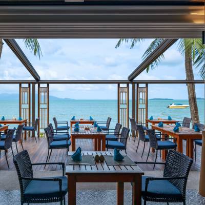 a dining room table in front of a body of water