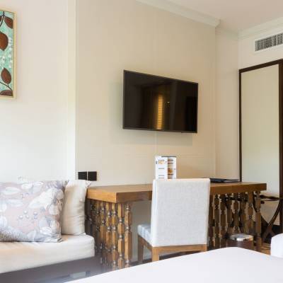 a bedroom with a bed and a chair in a room